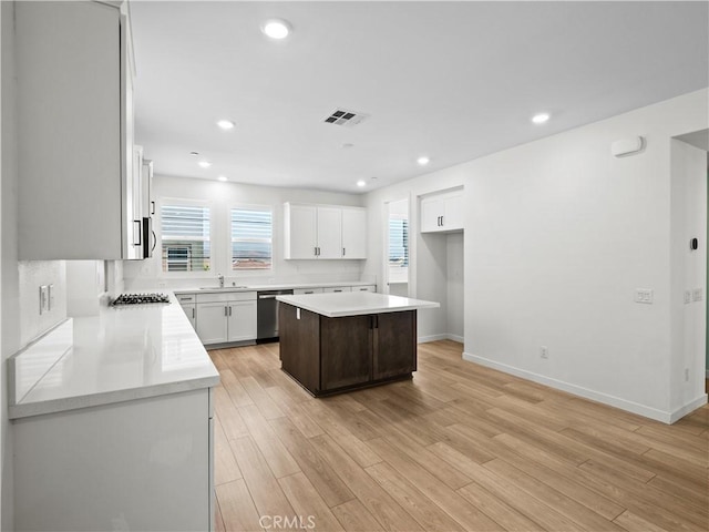 27148 Valley Oak Pl, Valencia, CA 91381 - kitchen with dishwasher, healthy amount of natural light, a center island, light wood-style floors, and recessed lighting