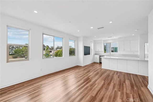 301 Placemark, Irvine, CA 92614 - unfurnished living room with light wood-style floors, healthy amount of natural light, and recessed lighting