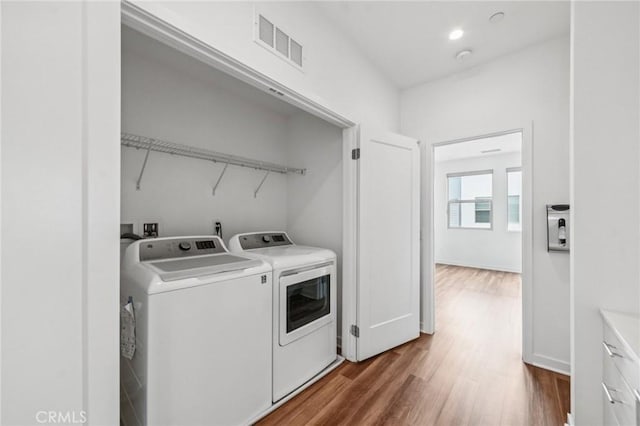 301 Placemark, Irvine, CA 92614 - washroom featuring washer and dryer and dark wood-type flooring
