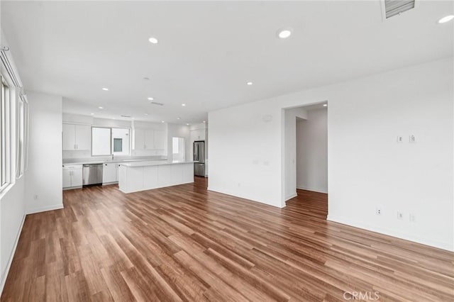 301 Placemark, Irvine, CA 92614 - unfurnished living room featuring light wood-type flooring and recessed lighting