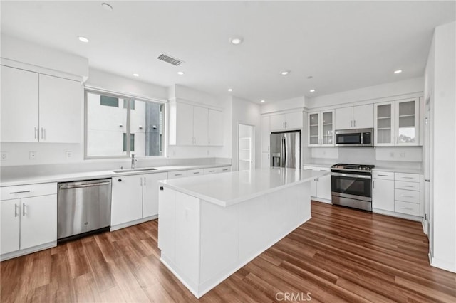 301 Placemark, Irvine, CA 92614 - kitchen featuring appliances with stainless steel finishes, white cabinetry, a center island, light countertops, and recessed lighting