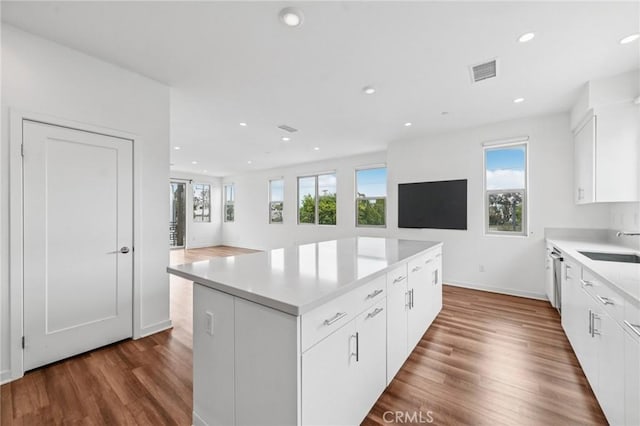 301 Placemark, Irvine, CA 92614 - kitchen with healthy amount of natural light, dark wood-style floors, a center island, and recessed lighting