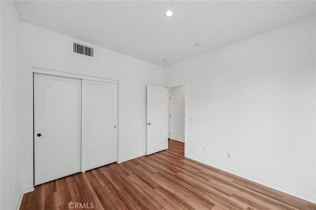 301 Placemark, Irvine, CA 92614 - unfurnished bedroom featuring wood finished floors and a closet