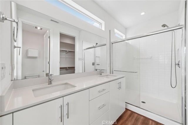 301 Placemark, Irvine, CA 92614 - full bath featuring a stall shower, double vanity, wood finished floors, a spacious closet, and recessed lighting