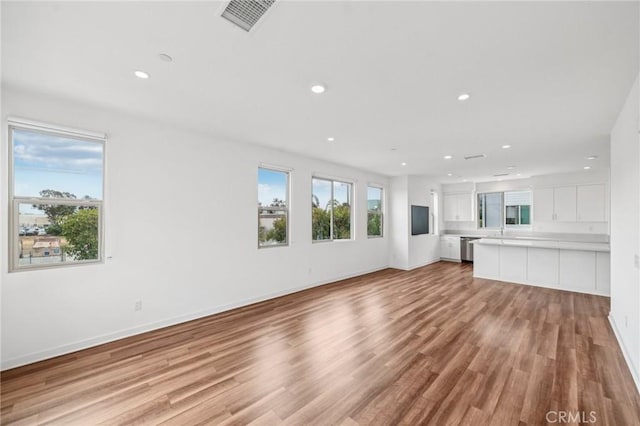 301 Placemark, Irvine, CA 92614 - unfurnished living room featuring recessed lighting and light wood-style floors