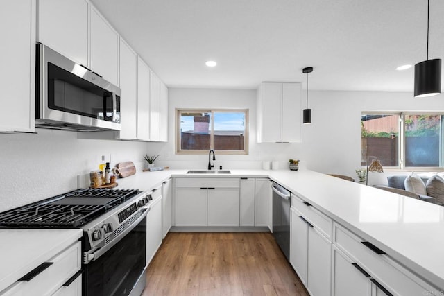 9121 Heatherdale St, Santee, CA 92071 - kitchen with stainless steel appliances, light wood-type flooring, light countertops, healthy amount of natural light, and recessed lighting