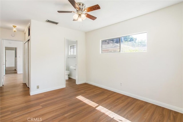 722 E 19th St, San Bernardino, CA 92404 - unfurnished bedroom featuring wood finished floors, connected bathroom, and a closet