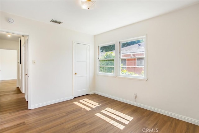 722 E 19th St, San Bernardino, CA 92404 - unfurnished bedroom with baseboards and wood finished floors
