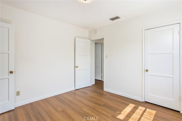 722 E 19th St, San Bernardino, CA 92404 - unfurnished bedroom with light wood finished floors and baseboards
