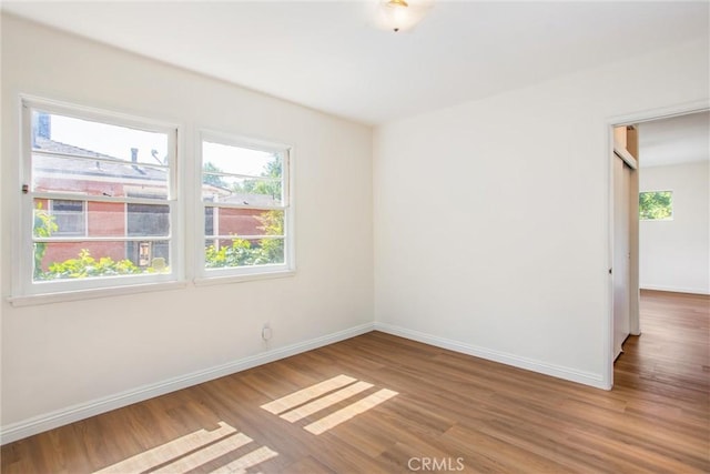 722 E 19th St, San Bernardino, CA 92404 - empty room featuring plenty of natural light and wood finished floors