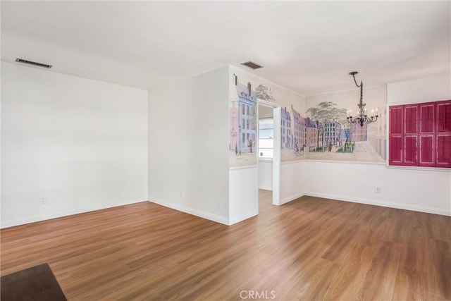 722 E 19th St, San Bernardino, CA 92404 - empty room with a chandelier and wood finished floors