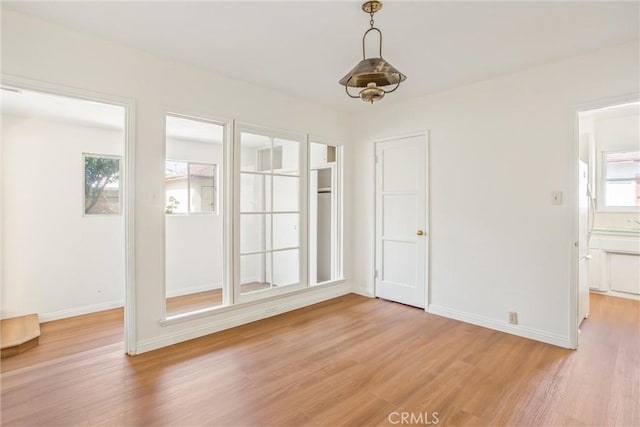 722 E 19th St, San Bernardino, CA 92404 - unfurnished dining area featuring light wood-style flooring and baseboards