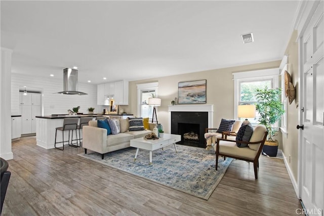 4841 E Los Coyotes Diagonal, Long Beach, CA 90815 - living area featuring wood finished floors, recessed lighting, and a fireplace