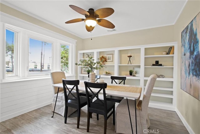 4841 E Los Coyotes Diagonal, Long Beach, CA 90815 - dining room with wood finished floors, a ceiling fan, and crown molding