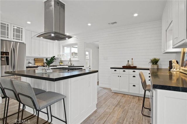 4841 E Los Coyotes Diagonal, Long Beach, CA 90815 - kitchen with island exhaust hood, dark countertops, a kitchen bar, stainless steel appliances, and recessed lighting