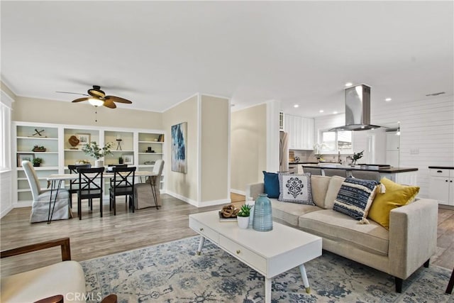 4841 E Los Coyotes Diagonal, Long Beach, CA 90815 - living room featuring light wood finished floors and ceiling fan