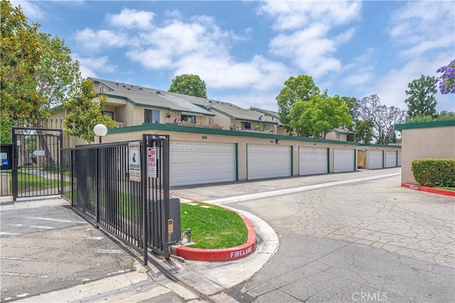 13801 Shirley St Unit 14, Garden Grove, CA 92843 - view of road with community garages, a gate, and curbs