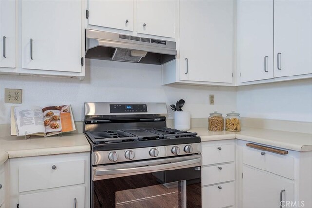 13801 Shirley St Unit 14, Garden Grove, CA 92843 - kitchen with stainless steel range with gas stovetop, under cabinet range hood, white cabinetry, and light countertops
