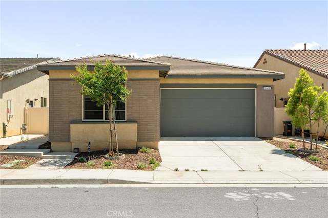 1649 Spring Run Ln, Beaumont, CA 92223 - view of front of property with a garage, concrete driveway, stucco siding, and a tiled roof