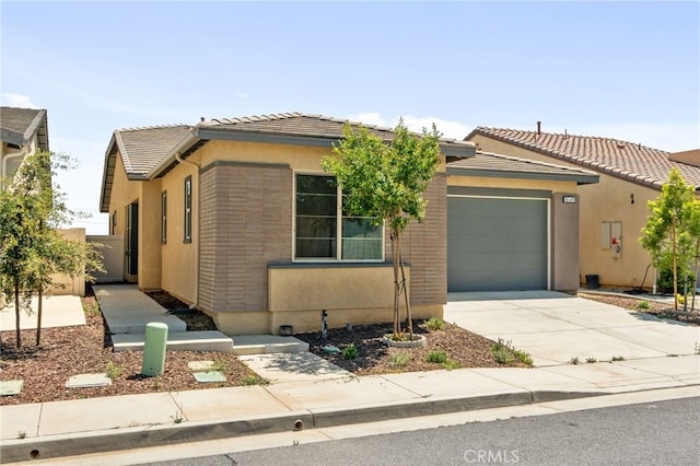 1649 Spring Run Ln, Beaumont, CA 92223 - view of front of house with concrete driveway, an attached garage, a tile roof, and stucco siding