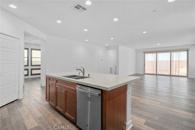 1649 Spring Run Ln, Beaumont, CA 92223 - kitchen with dishwasher, light wood-style floors, a kitchen island with sink, recessed lighting, and light countertops