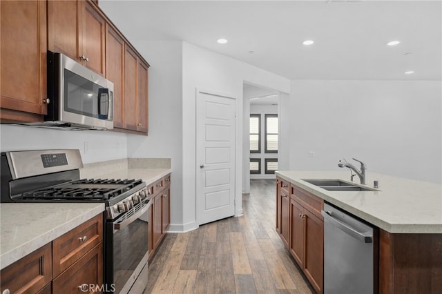 1649 Spring Run Ln, Beaumont, CA 92223 - kitchen with stainless steel appliances, wood finished floors, recessed lighting, light countertops, and a kitchen island with sink