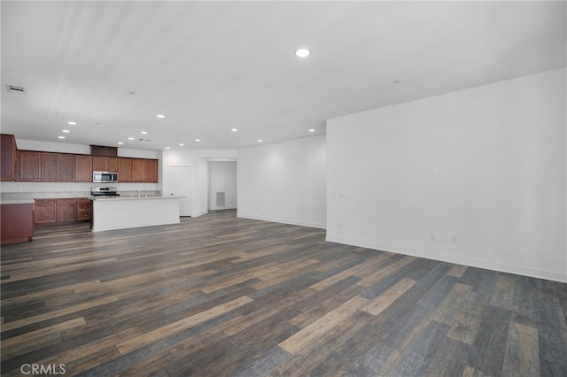 1649 Spring Run Ln, Beaumont, CA 92223 - unfurnished living room featuring recessed lighting and dark wood-style flooring