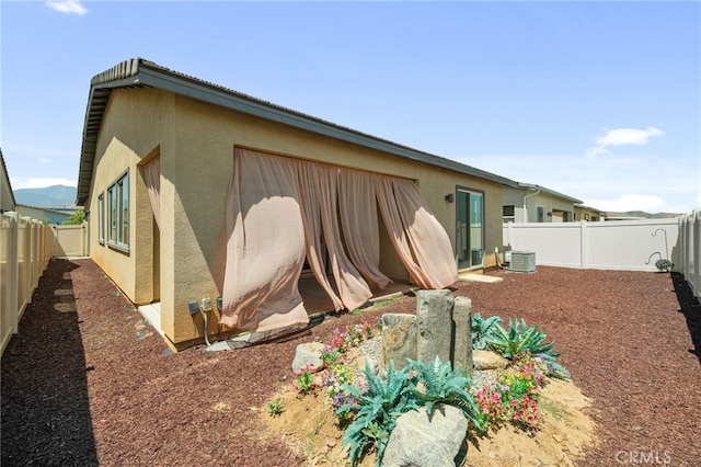 1649 Spring Run Ln, Beaumont, CA 92223 - back of house with stucco siding and a fenced backyard