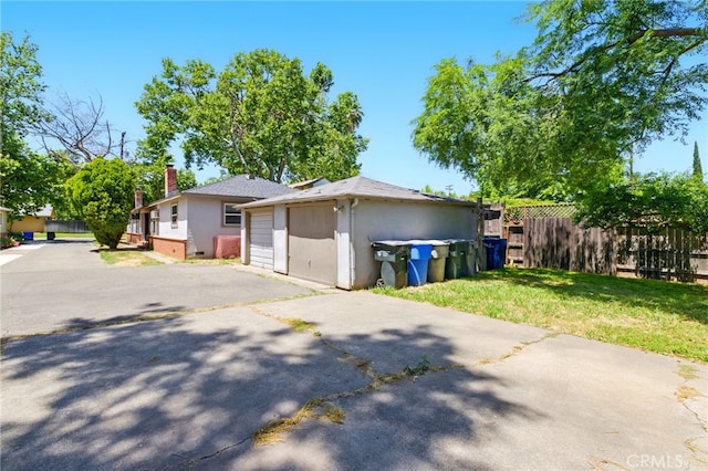 2723 57th St, Sacramento, CA 95817 - view of front facade featuring stucco siding, a chimney, and a detached garage