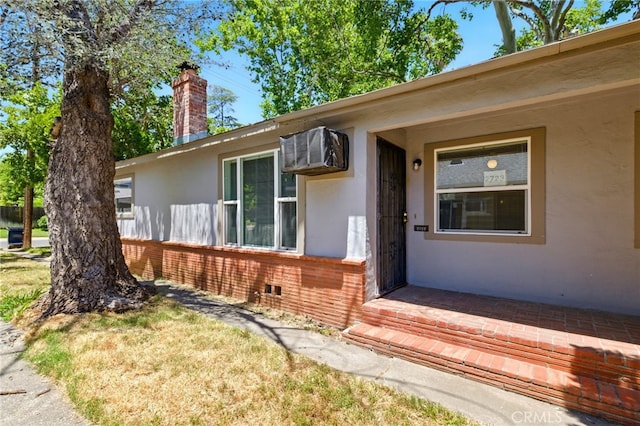 2723 57th St, Sacramento, CA 95817 - view of exterior entry featuring stucco siding, a chimney, and brick siding