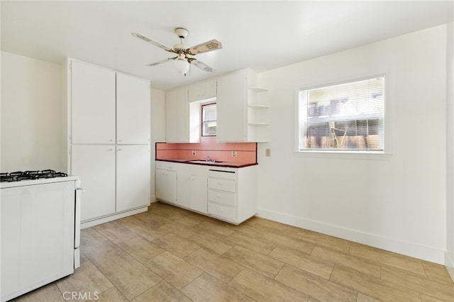 2723 57th St, Sacramento, CA 95817 - kitchen featuring white gas range, white cabinetry, open shelves, a ceiling fan, and dark countertops