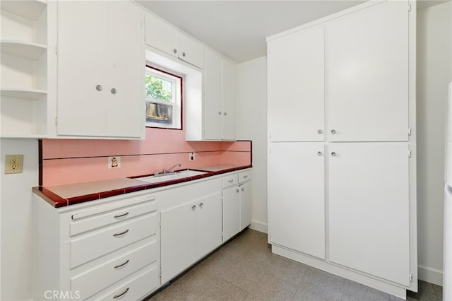 2723 57th St, Sacramento, CA 95817 - kitchen featuring open shelves, decorative backsplash, light floors, and white cabinets