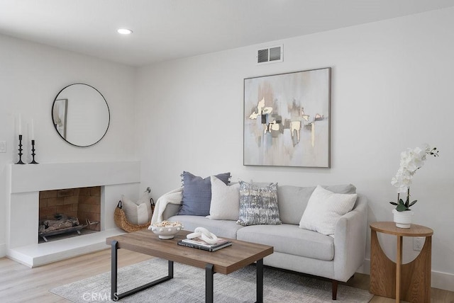 13020 Beach St, Cerritos, CA 90703 - living area with wood finished floors, a fireplace with raised hearth, and recessed lighting