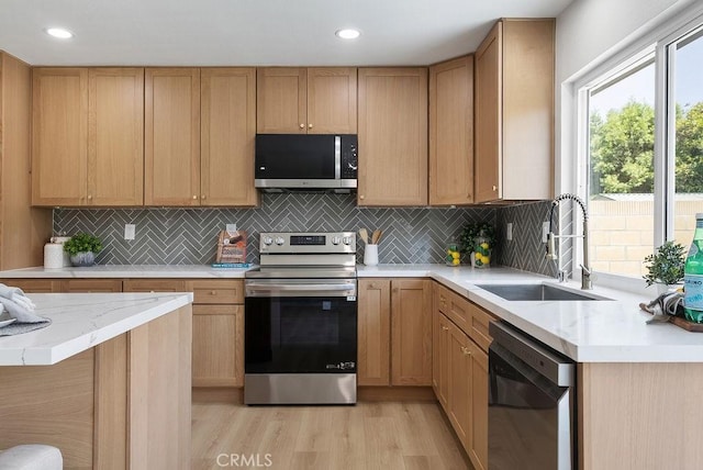 13020 Beach St, Cerritos, CA 90703 - kitchen with stainless steel appliances, light wood finished floors, backsplash, recessed lighting, and light stone counters