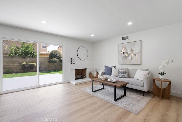 13020 Beach St, Cerritos, CA 90703 - living area with light wood-style floors, a fireplace with raised hearth, and recessed lighting