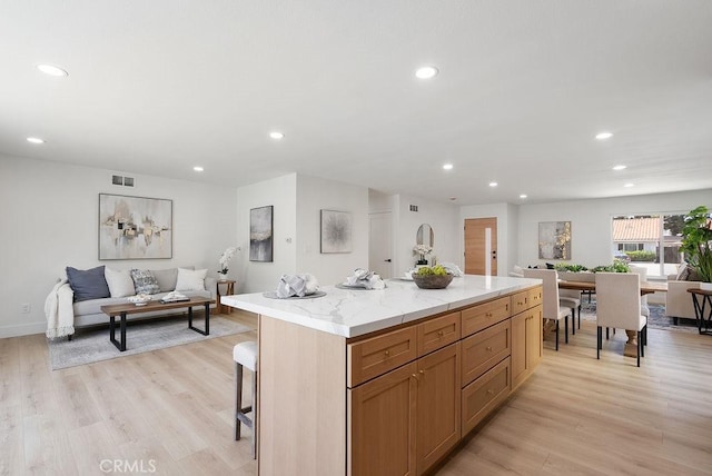 13020 Beach St, Cerritos, CA 90703 - kitchen featuring open floor plan, recessed lighting, light wood finished floors, a center island, and a kitchen breakfast bar