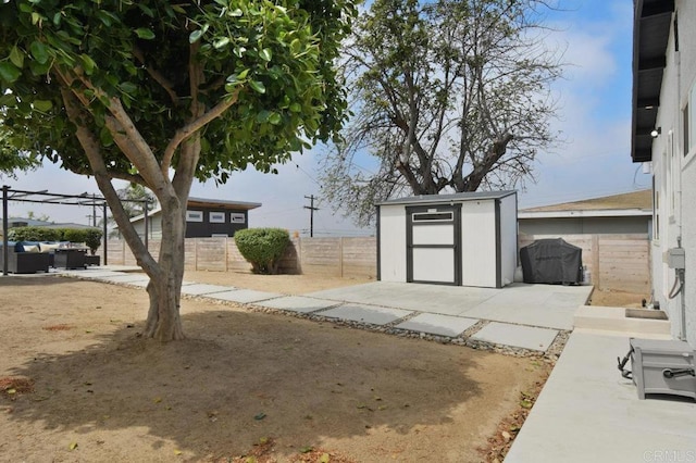6127 Winchester St, San Diego, CA 92139 - fenced backyard with a storage shed, a patio area, and outdoor lounge area