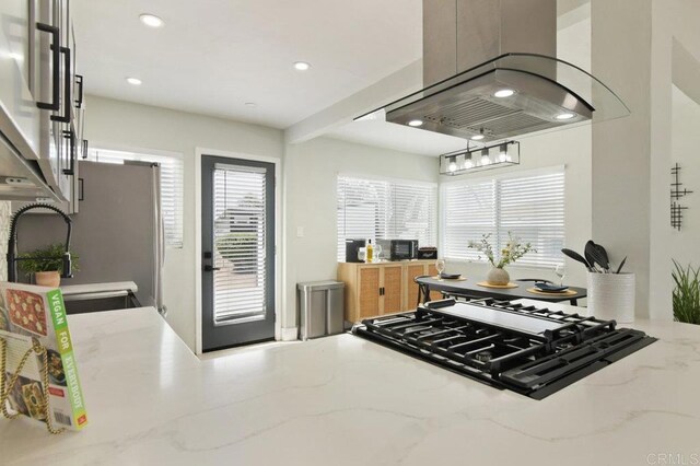 6127 Winchester St, San Diego, CA 92139 - kitchen featuring island exhaust hood, cooktop, recessed lighting, and light stone counters