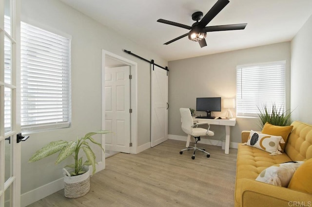 6127 Winchester St, San Diego, CA 92139 - office area featuring light wood-type flooring, a barn door, and ceiling fan