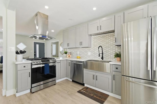 6127 Winchester St, San Diego, CA 92139 - kitchen with stainless steel appliances, island range hood, light countertops, light wood-style flooring, and recessed lighting