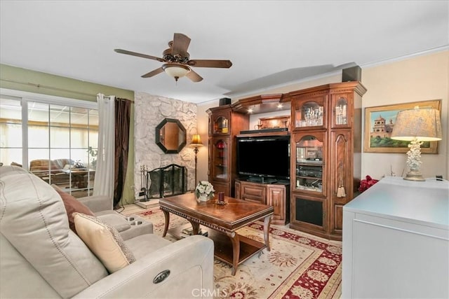 2374 Corydon Ave, Norco, CA 92860 - living room featuring ceiling fan, a stone fireplace, and crown molding