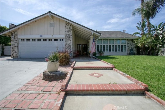 2374 Corydon Ave, Norco, CA 92860 - ranch-style home featuring stone siding, driveway, a front lawn, a garage, and board and batten siding