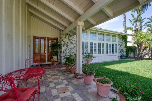 2374 Corydon Ave, Norco, CA 92860 - doorway to property with stone siding, board and batten siding, a yard, and a patio
