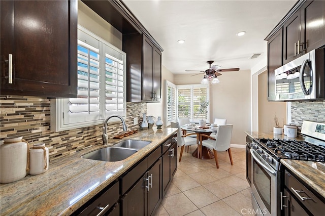 325 Sunrise St, Placentia, CA 92870 - kitchen featuring appliances with stainless steel finishes, backsplash, dark brown cabinetry, light tile patterned flooring, and a ceiling fan