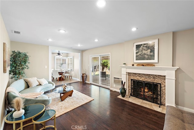 325 Sunrise St, Placentia, CA 92870 - living room featuring recessed lighting, wood finished floors, a tiled fireplace, a ceiling fan, and an AC wall unit