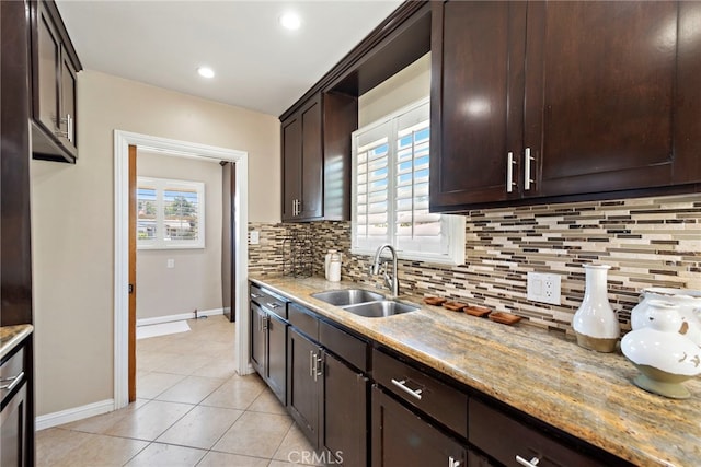 325 Sunrise St, Placentia, CA 92870 - kitchen with dark brown cabinetry, tasteful backsplash, light stone countertops, light tile patterned floors, and recessed lighting