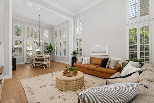 19256 Jasper Hill Rd, Lake Forest, CA 92679 - living area with a high ceiling, a chandelier, light wood-type flooring, healthy amount of natural light, and ornamental molding