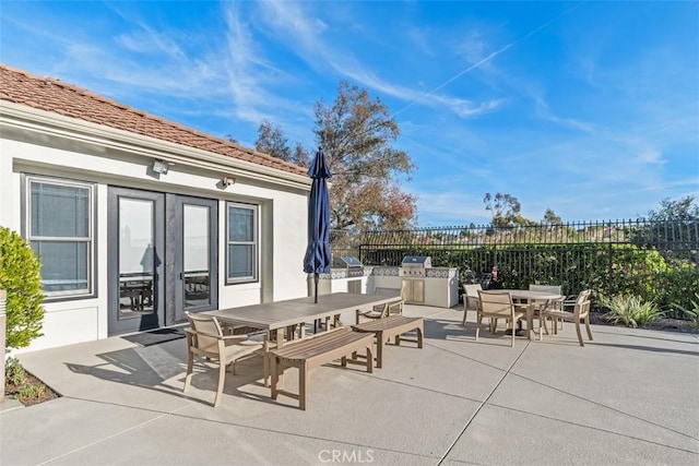 19256 Jasper Hill Rd, Lake Forest, CA 92679 - view of patio / terrace with outdoor dining space, an outdoor kitchen, and french doors
