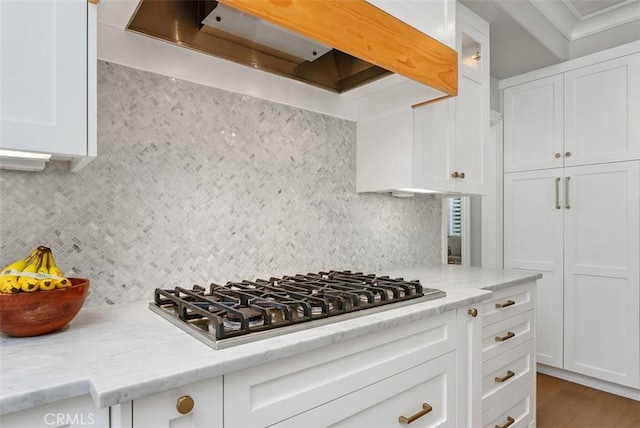 19256 Jasper Hill Rd, Lake Forest, CA 92679 - kitchen with premium range hood, stainless steel gas stovetop, backsplash, and white cabinetry