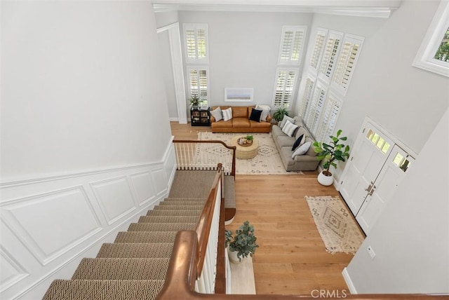 19256 Jasper Hill Rd, Lake Forest, CA 92679 - staircase featuring wood finished floors, crown molding, and a high ceiling